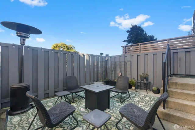 a view of a patio with couple of chairs