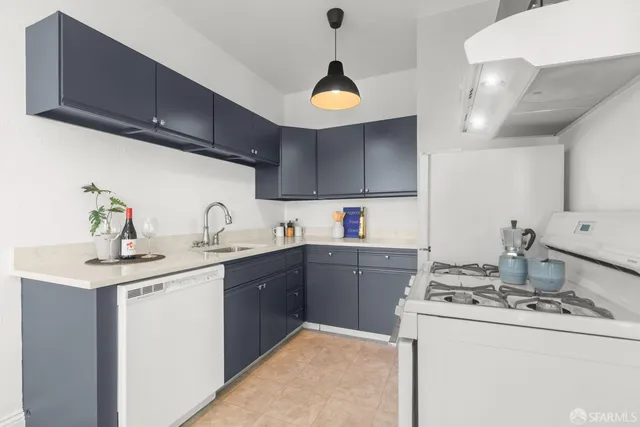 a kitchen with a sink a stove and cabinets