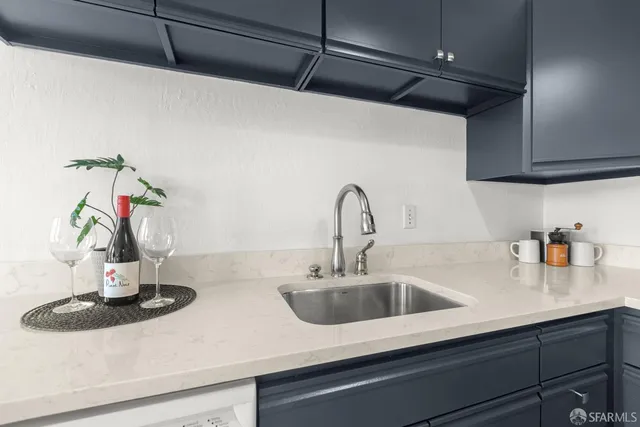 a kitchen with a sink and a potted plant