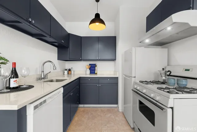 a kitchen with a sink stove and cabinets