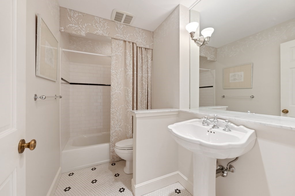 412 Beacon Street, Unit 6 Boston, MA 02115 - Photo 14 of 16 a bathroom with a sink a toilet a mirror and shower