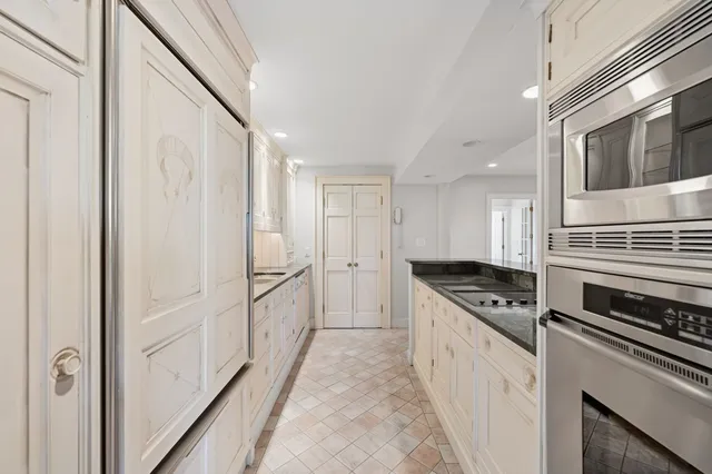 a kitchen with cabinets and white appliances