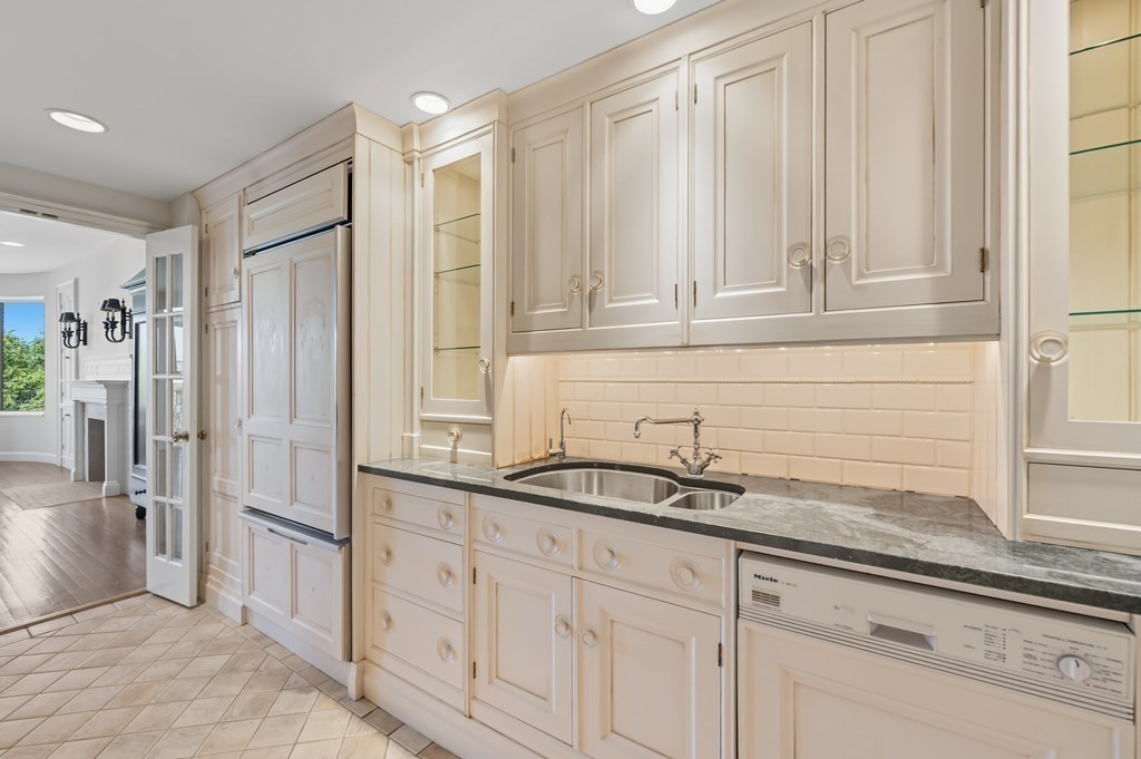 412 Beacon Street, Unit 6 Boston, MA 02115 - Photo 7 of 16 a kitchen with stainless steel appliances granite countertop white cabinets and a granite counter tops