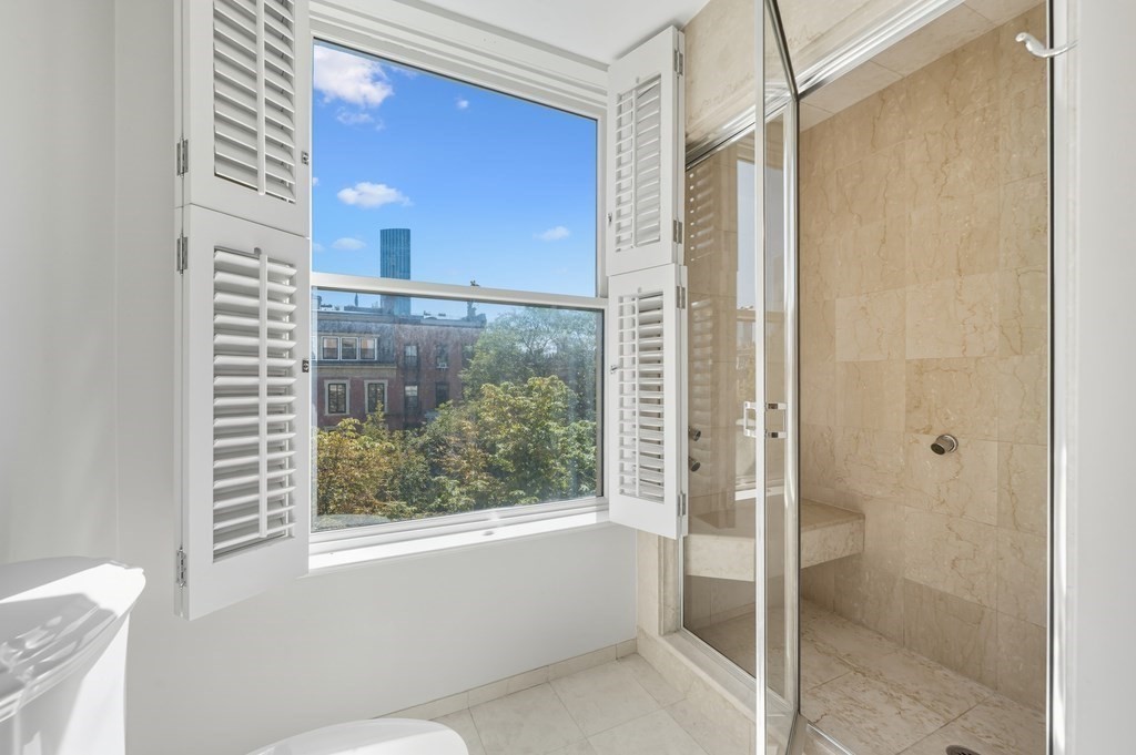 412 Beacon Street, Unit 6 Boston, MA 02115 - Photo 8 of 16 a bathroom with a bathtub and a shower