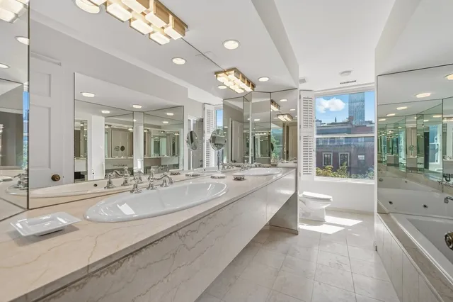a large bathroom with a large tub and sink