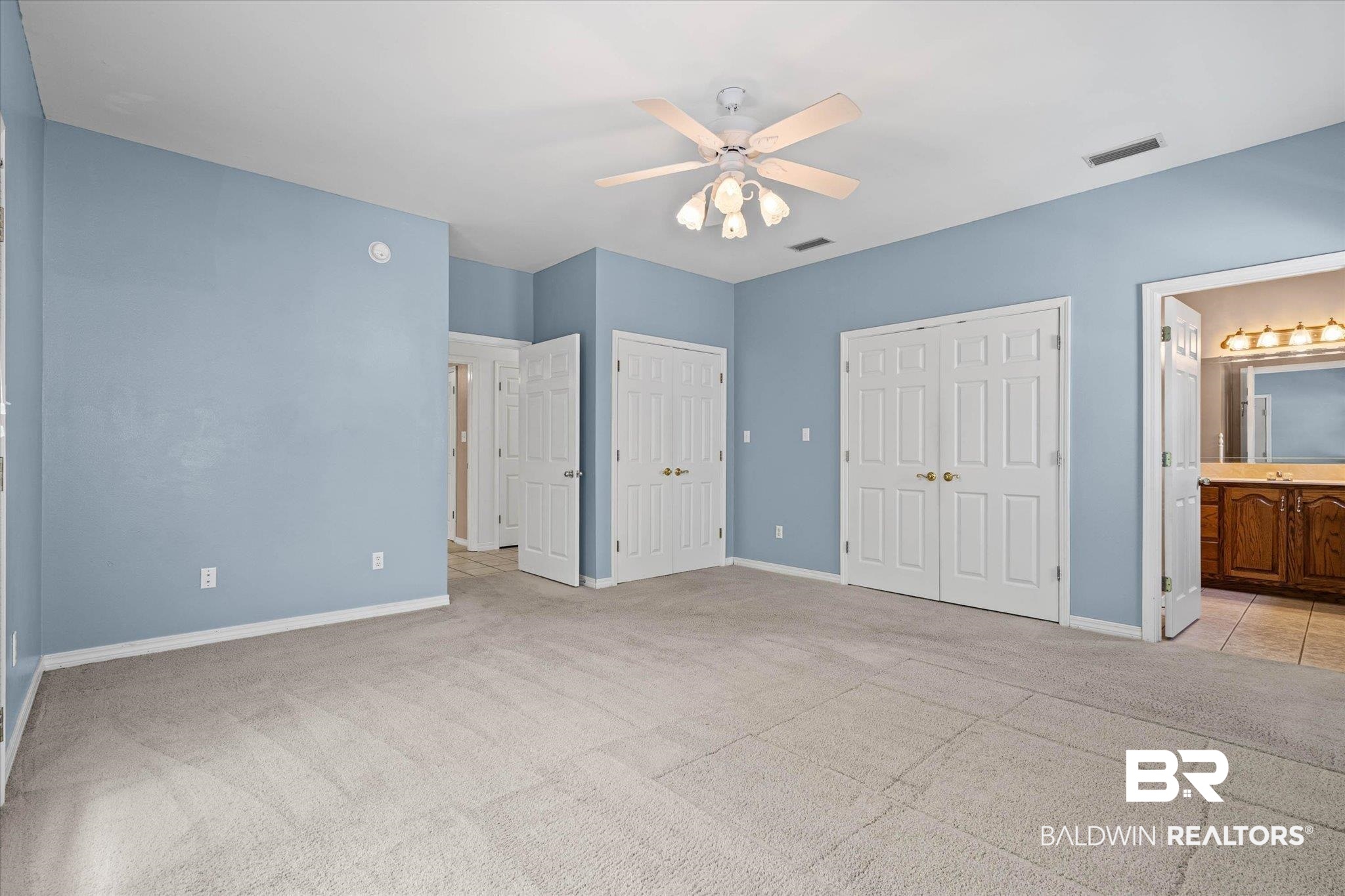 41923 Bayou Road Bay Minette, AL 36507 - Photo 14 of 35 Spacious room featuring light blue walls, soft neutral carpeting, and a ceiling fan with integrated lighting