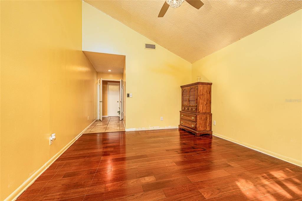 2903 Silver Ridge Drive Orlando, FL 32818 - Photo 14 of 27 a view of an empty room with wooden floor