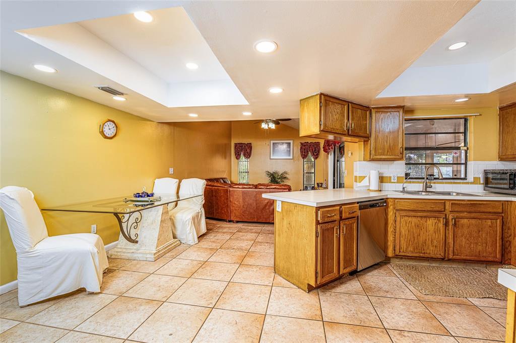 2903 Silver Ridge Drive Orlando, FL 32818 - Photo 17 of 27 a large kitchen with stainless steel appliances a sink and cabinets