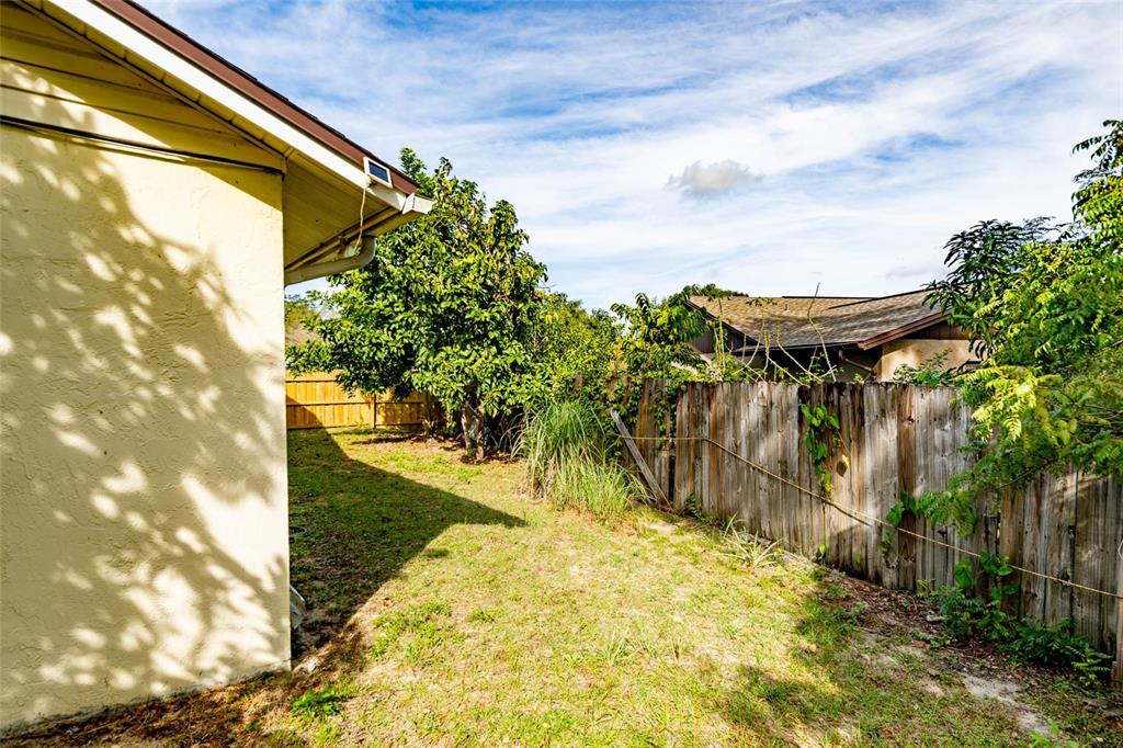 2903 Silver Ridge Drive Orlando, FL 32818 - Photo 26 of 27 a view of a pathway of a building in the background