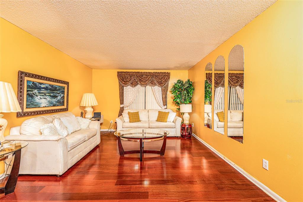 2903 Silver Ridge Drive Orlando, FL 32818 - Photo 4 of 27 a living room with furniture and a large window