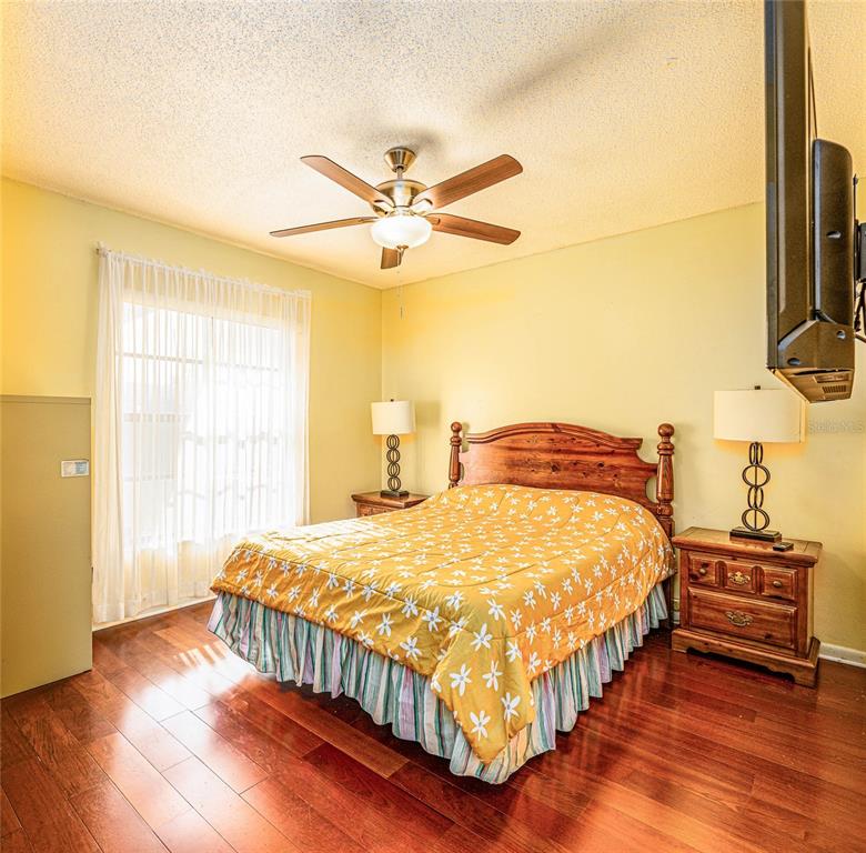 2903 Silver Ridge Drive Orlando, FL 32818 - Photo 6 of 27 a bedroom with a bed and wooden floor