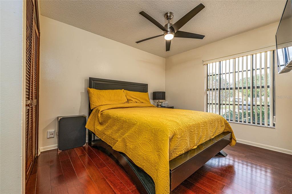 2903 Silver Ridge Drive Orlando, FL 32818 - Photo 7 of 27 a bedroom with a bed and wooden floor