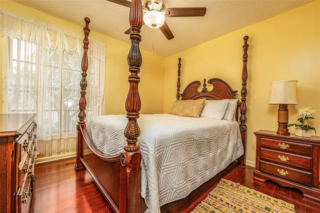 2903 Silver Ridge Drive Orlando, FL 32818 - Photo 8 of 27 a bedroom with a bed and wooden floor