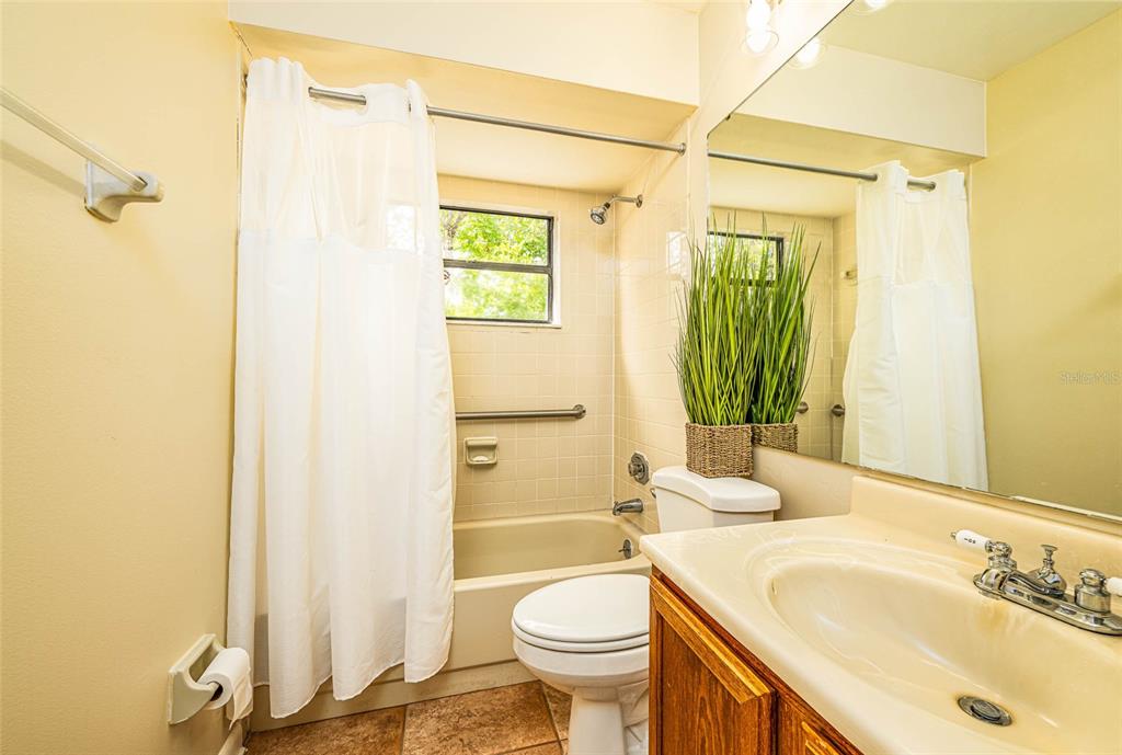 2903 Silver Ridge Drive Orlando, FL 32818 - Photo 9 of 27 a bathroom with a sink toilet and shower
