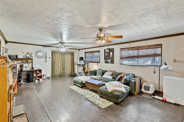 a bedroom with furniture and a large window