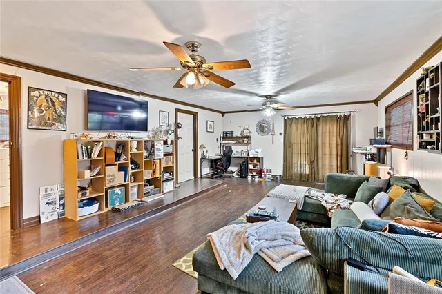 a living room with furniture and wooden floor