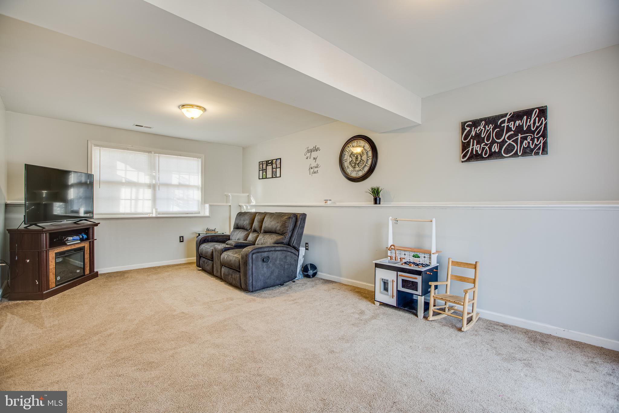 12 Johnson Drive Ruther Glen, VA 22546 - Photo 17 of 33 Basement family room with carpet floors.