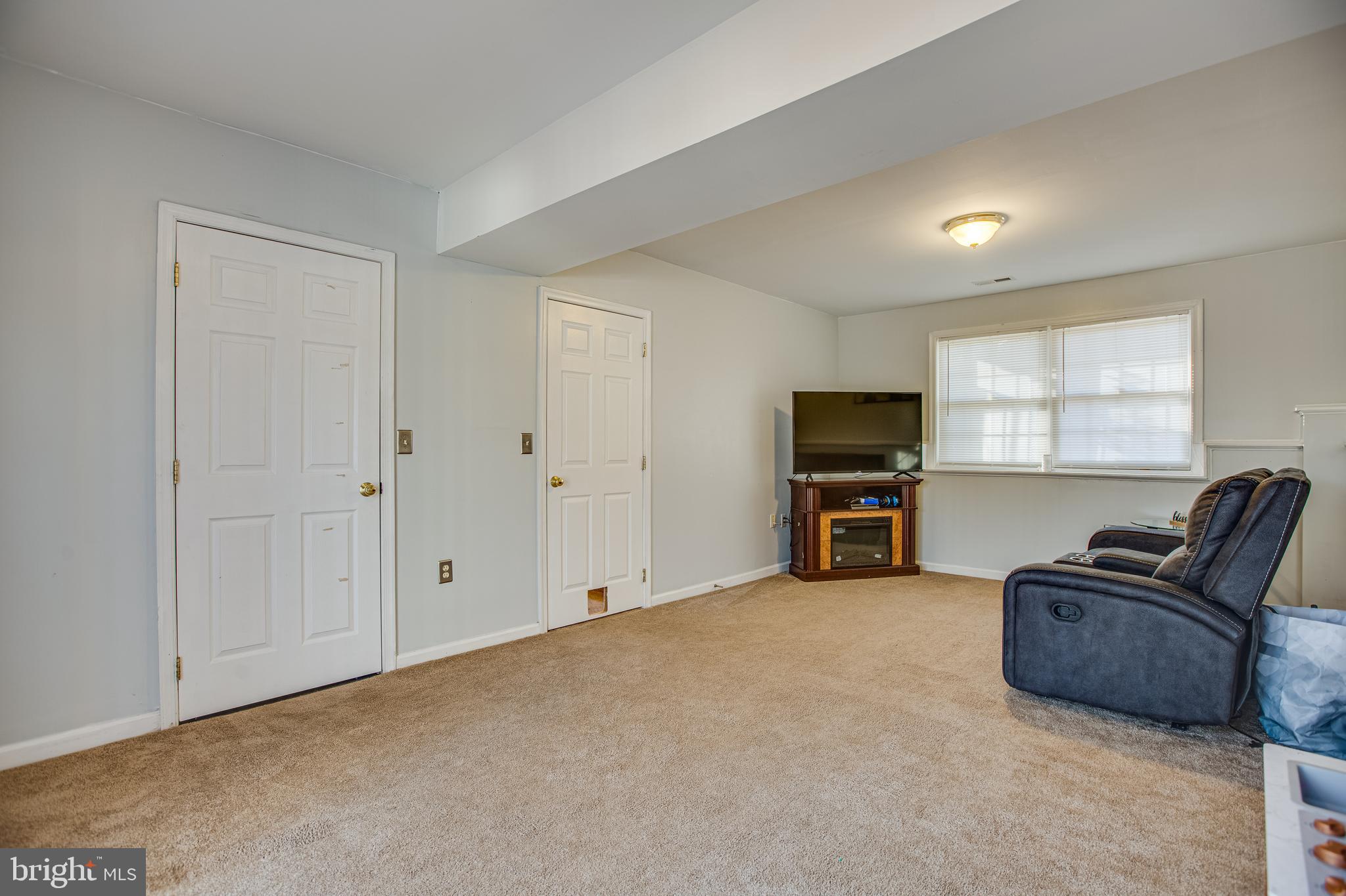 12 Johnson Drive Ruther Glen, VA 22546 - Photo 18 of 33 Comfortable family room with carpet floors.