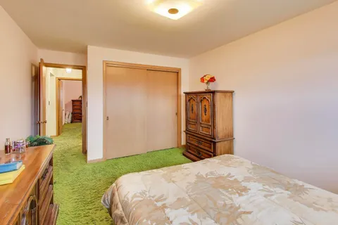 a view of a house with backyard and trees