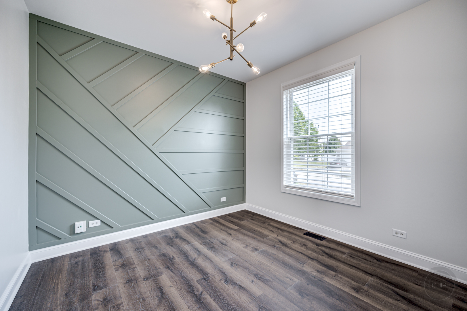 12948 Parterre Place Plainfield, IL 60585 - Photo 6 of 35 a view of an empty room with wooden floor and a window