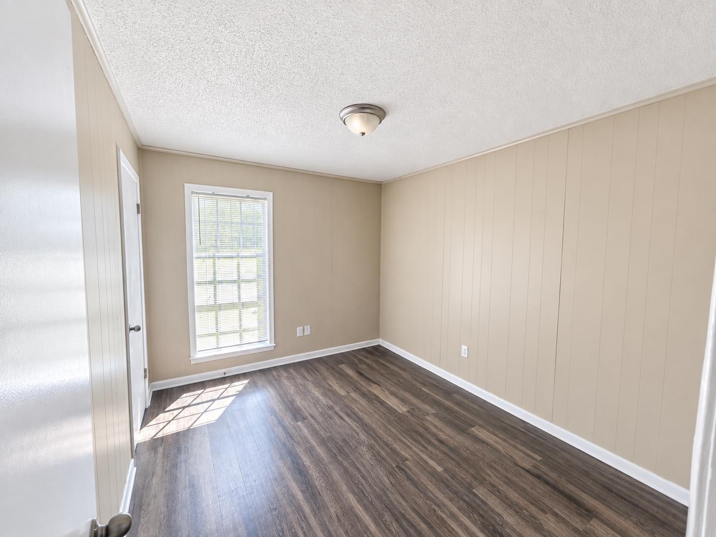 630 Blackhawk Road Memphis, TN 38109 - Photo 14 of 14 Wood-finish flooring, paneled wall accents, and an overhead flush mount light fixture