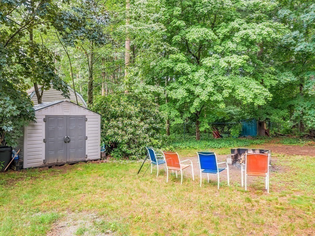 15 A Sylvan Road, Unit 2 Billerica, MA 01821 - Photo 27 of 28 a backyard of a house with table and chairs