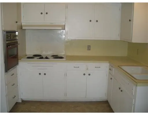 a kitchen with cabinets and appliances