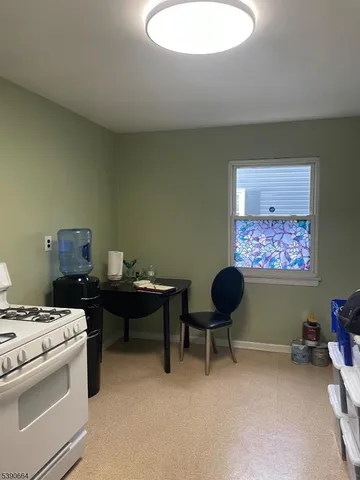 a living room with furniture and a painting on the wall