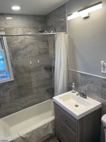 a bathroom with a sink mirror toilet and bathtub