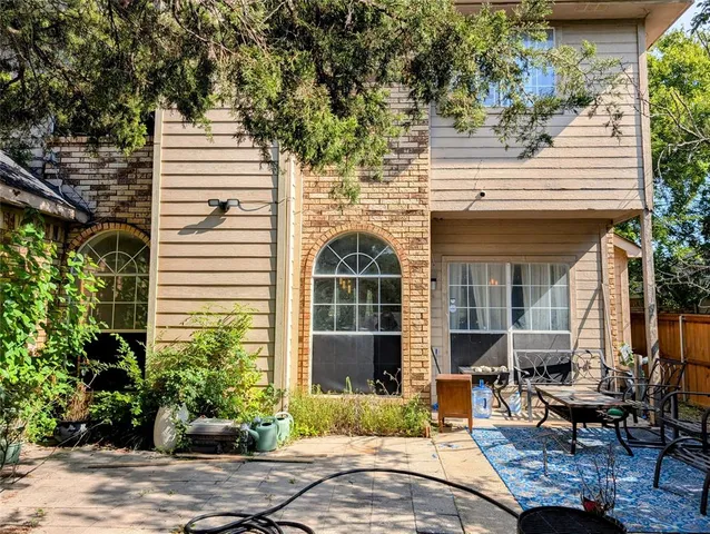 a view of a house with backyard stove and sitting area