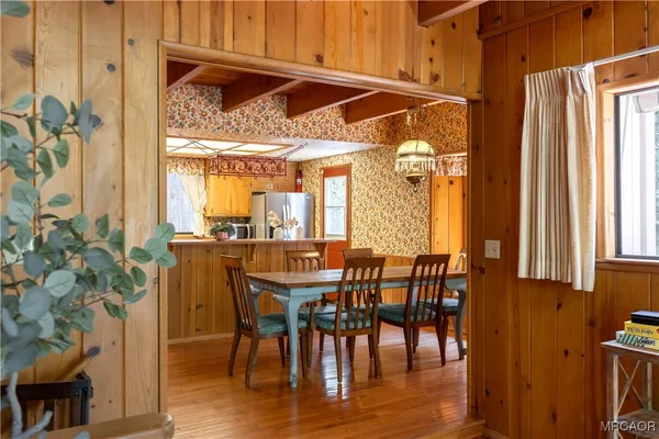 a view of a dining room with furniture and window