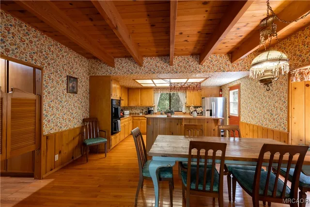 a dining room with furniture and wooden floor