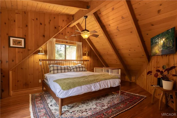 a bed sitting in a bedroom next to a window