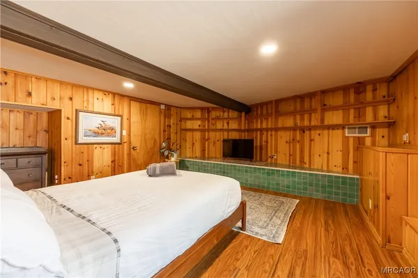 a bedroom with a bed window and a table