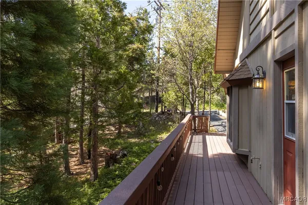a view of a balcony with wooden floor