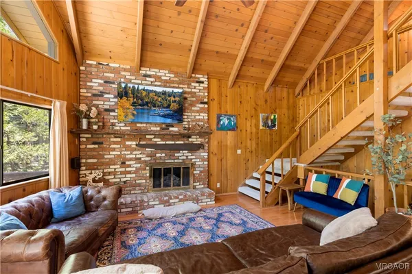 a living room with furniture fireplace and a window
