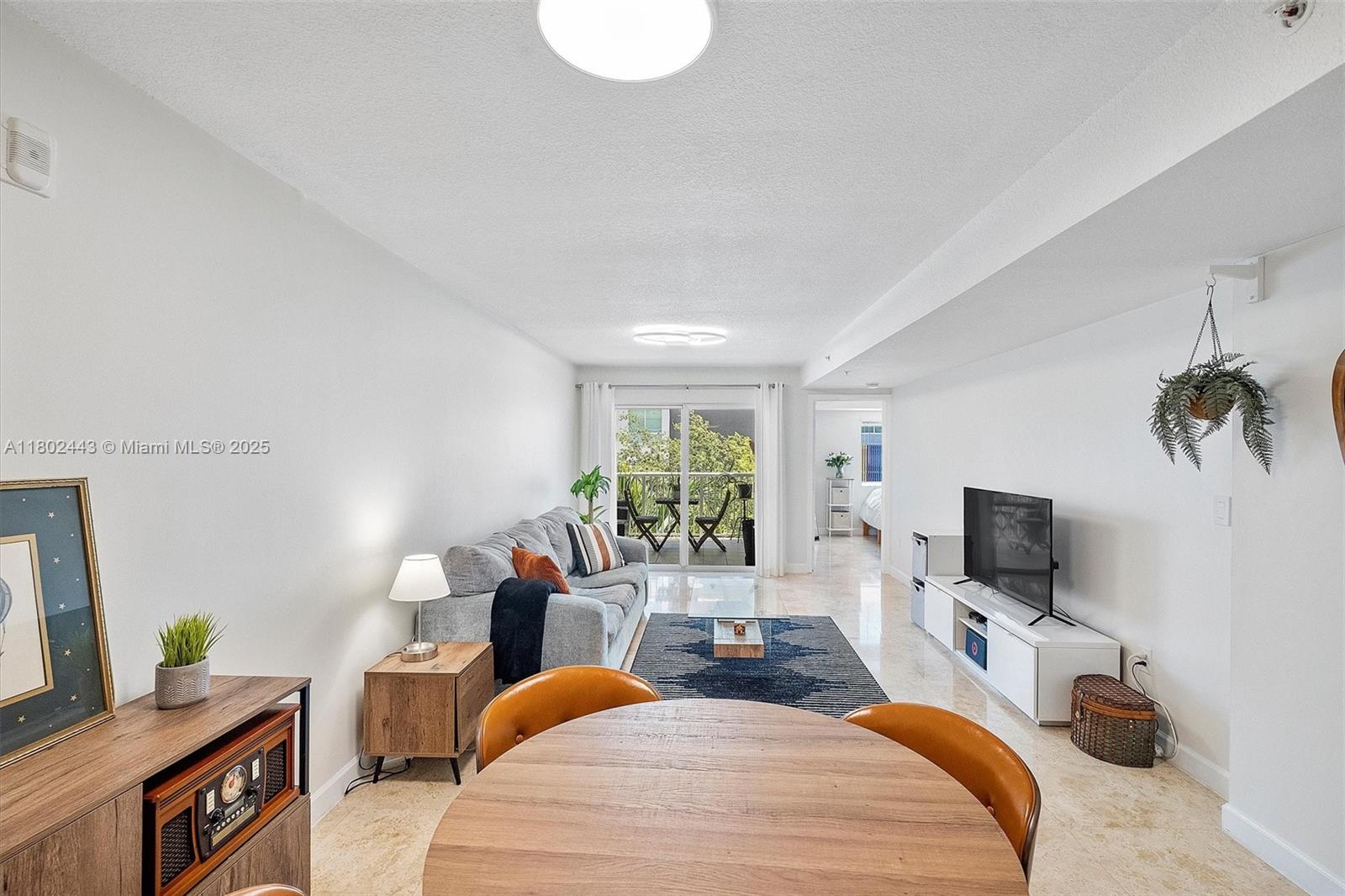 280 Southwest 20th Road, Unit 407 Miami, FL 33129 - Photo 1 of 23 a bedroom with a bed a flat screen tv and a couch