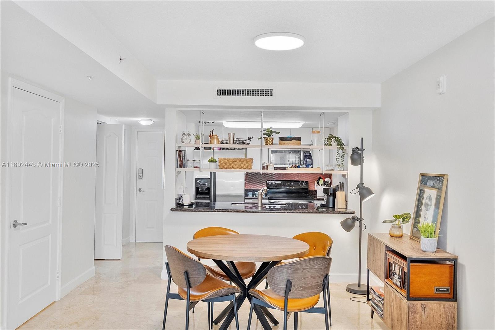 280 Southwest 20th Road, Unit 407 Miami, FL 33129 - Photo 3 of 23 a kitchen with stainless steel appliances granite countertop a sink and a refrigerator