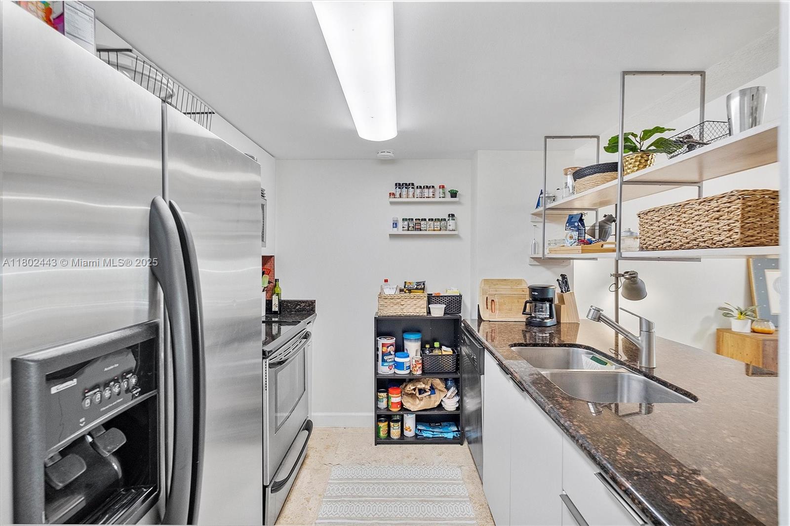 280 Southwest 20th Road, Unit 407 Miami, FL 33129 - Photo 5 of 23 a kitchen with stainless steel appliances granite countertop a refrigerator and a sink
