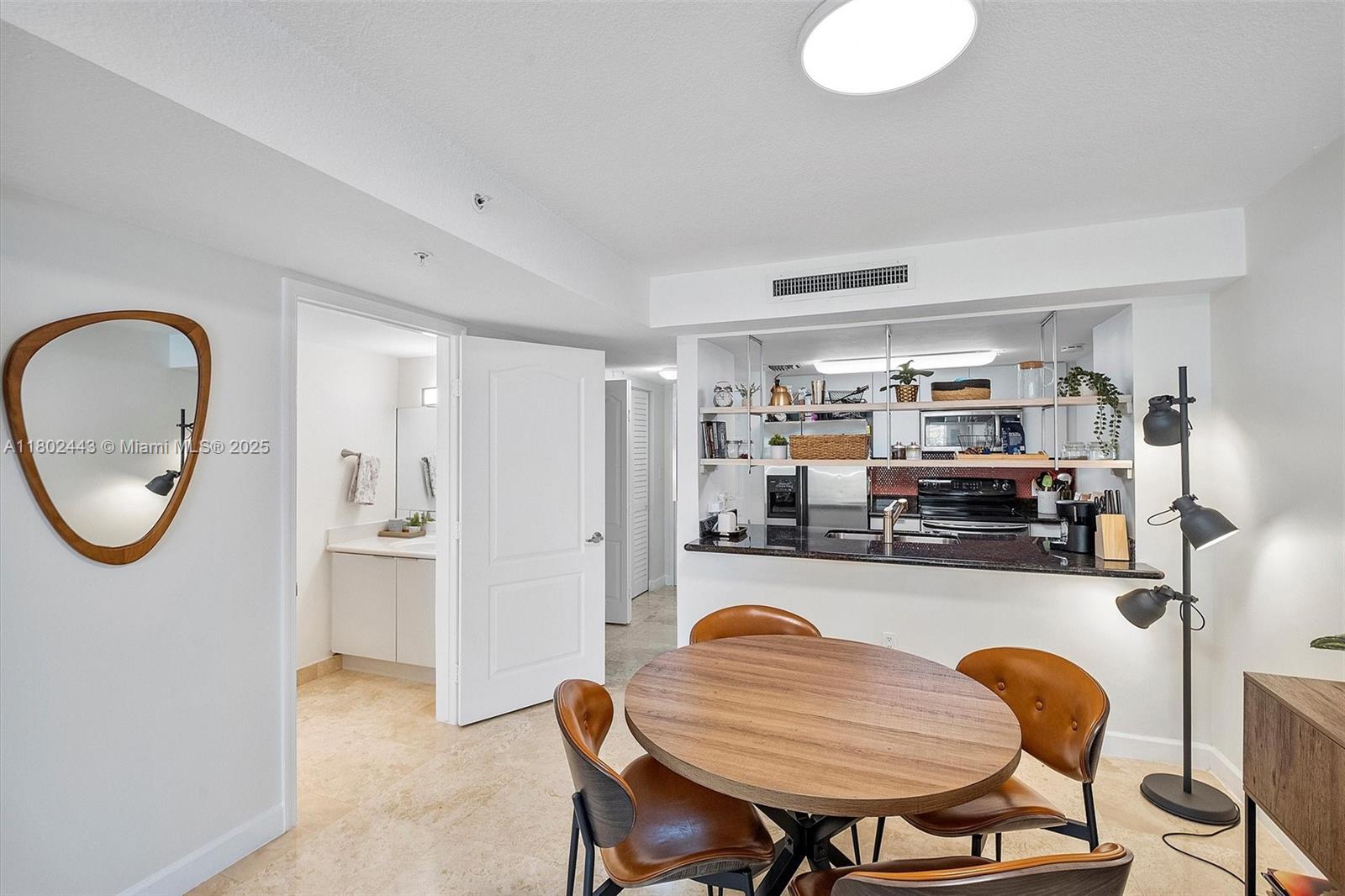 280 Southwest 20th Road, Unit 407 Miami, FL 33129 - Photo 7 of 23 a dining room with furniture and a mirror