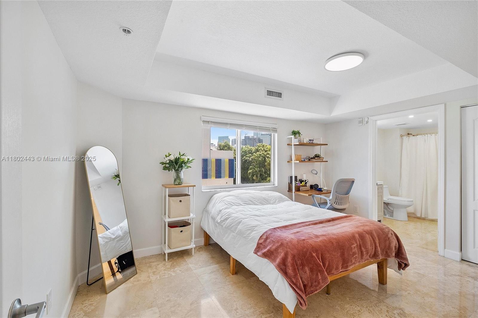 280 Southwest 20th Road, Unit 407 Miami, FL 33129 - Photo 9 of 23 a bedroom with a bed and a large window