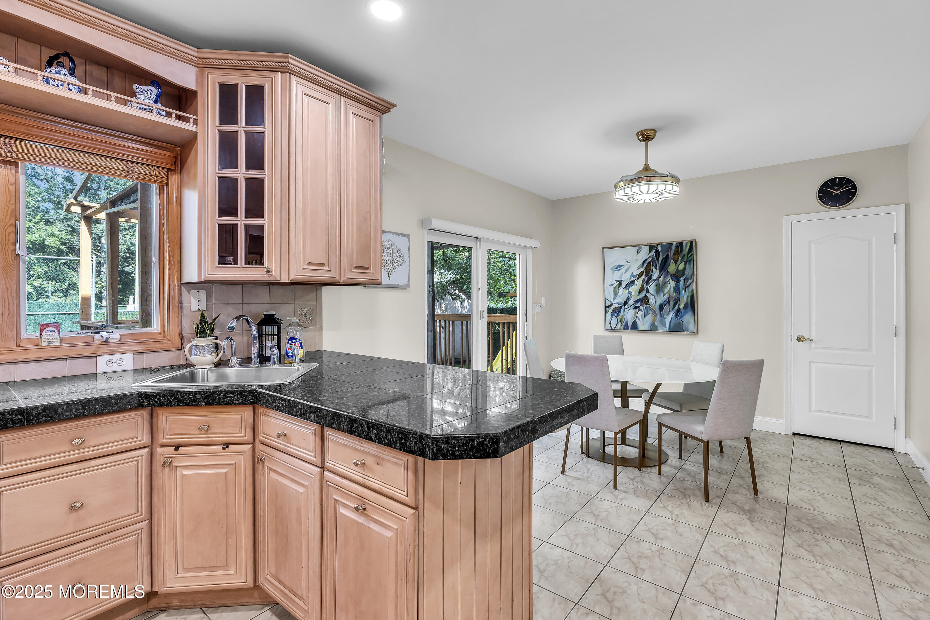 100 Case Road Lakewood, NJ 08701 - Photo 12 of 36 a kitchen with granite countertop a sink a center island cabinets and a window