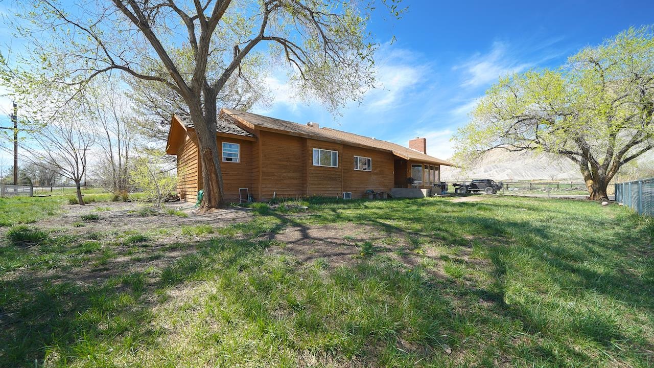 3458 G Road Clifton, CO 81520 - Photo 30 of 30 a brick house with a big yard plants and large trees