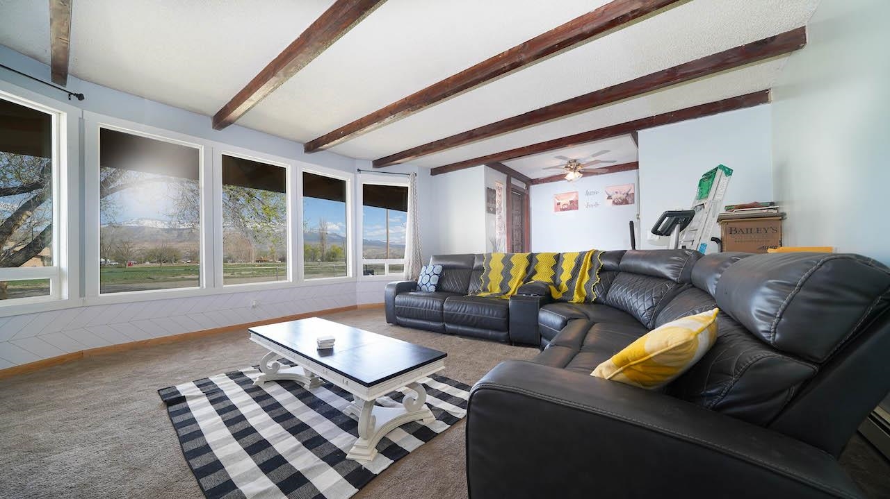 3458 G Road Clifton, CO 81520 - Photo 8 of 30 a living room with furniture ceiling fan and a large window