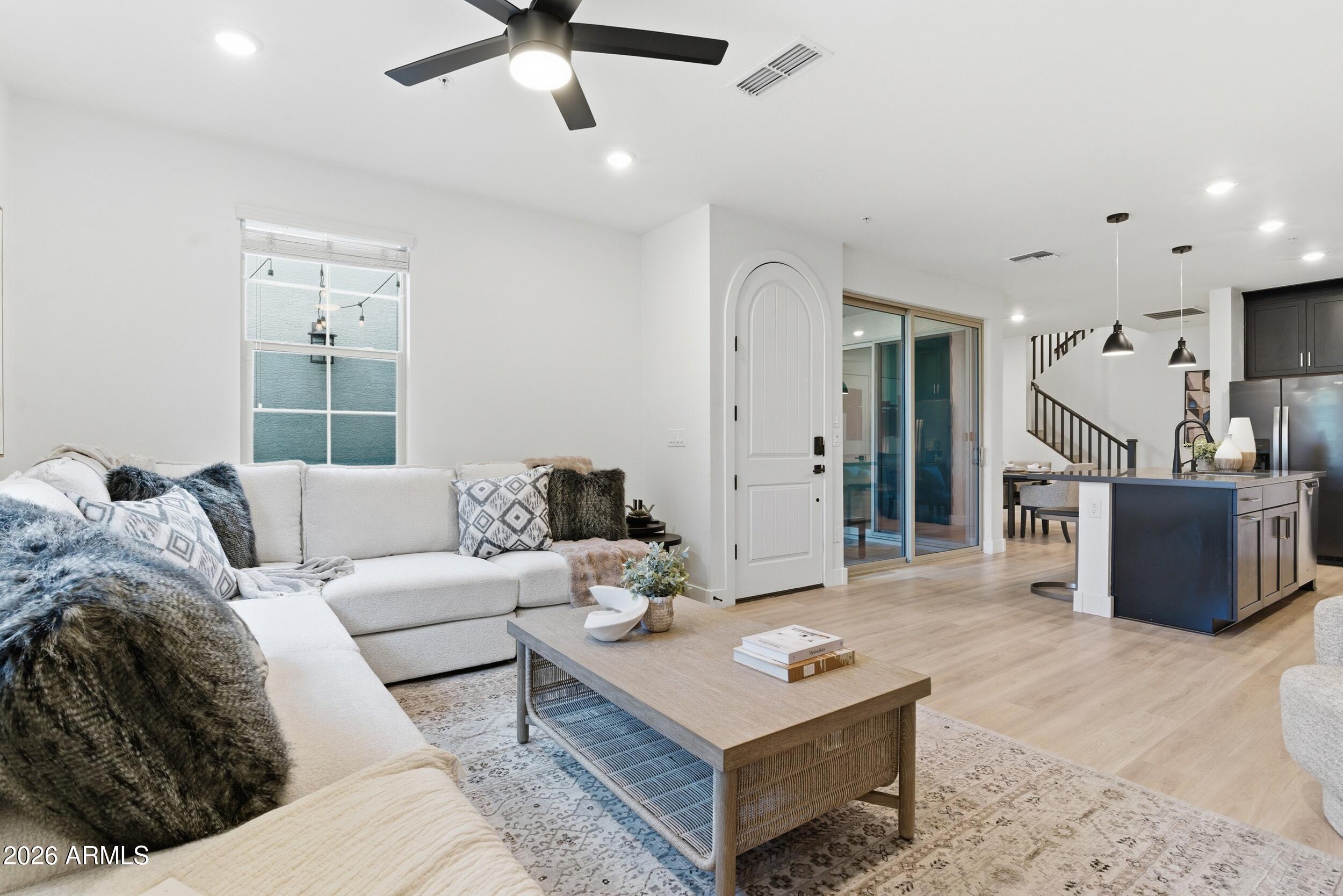 3855 South McQueen Road, Unit 34 Chandler, AZ 85286 - Photo 11 of 48 a living room with furniture and a wooden floor