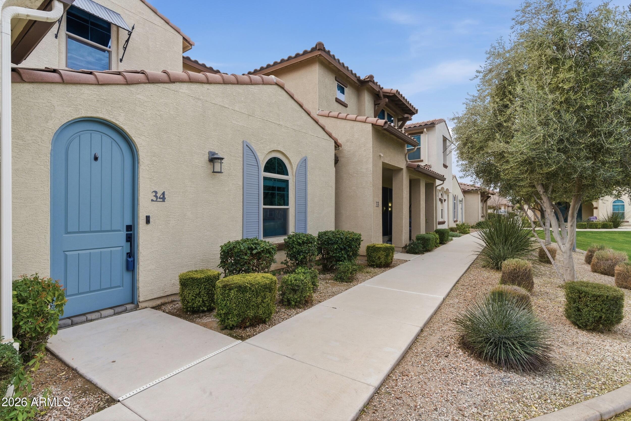 3855 South McQueen Road, Unit 34 Chandler, AZ 85286 - Photo 2 of 48 a front view of a house with garden