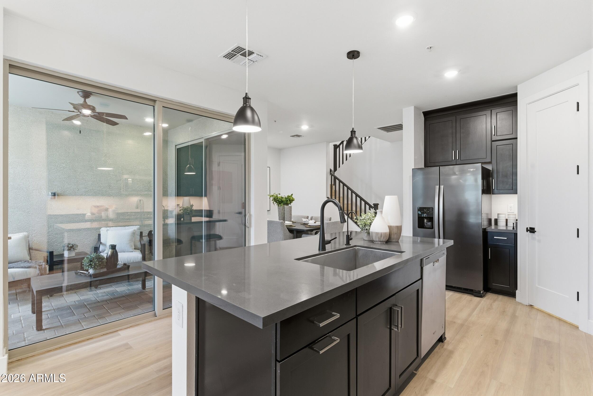 3855 South McQueen Road, Unit 34 Chandler, AZ 85286 - Photo 21 of 48 a kitchen with kitchen island a sink appliances and a counter top space