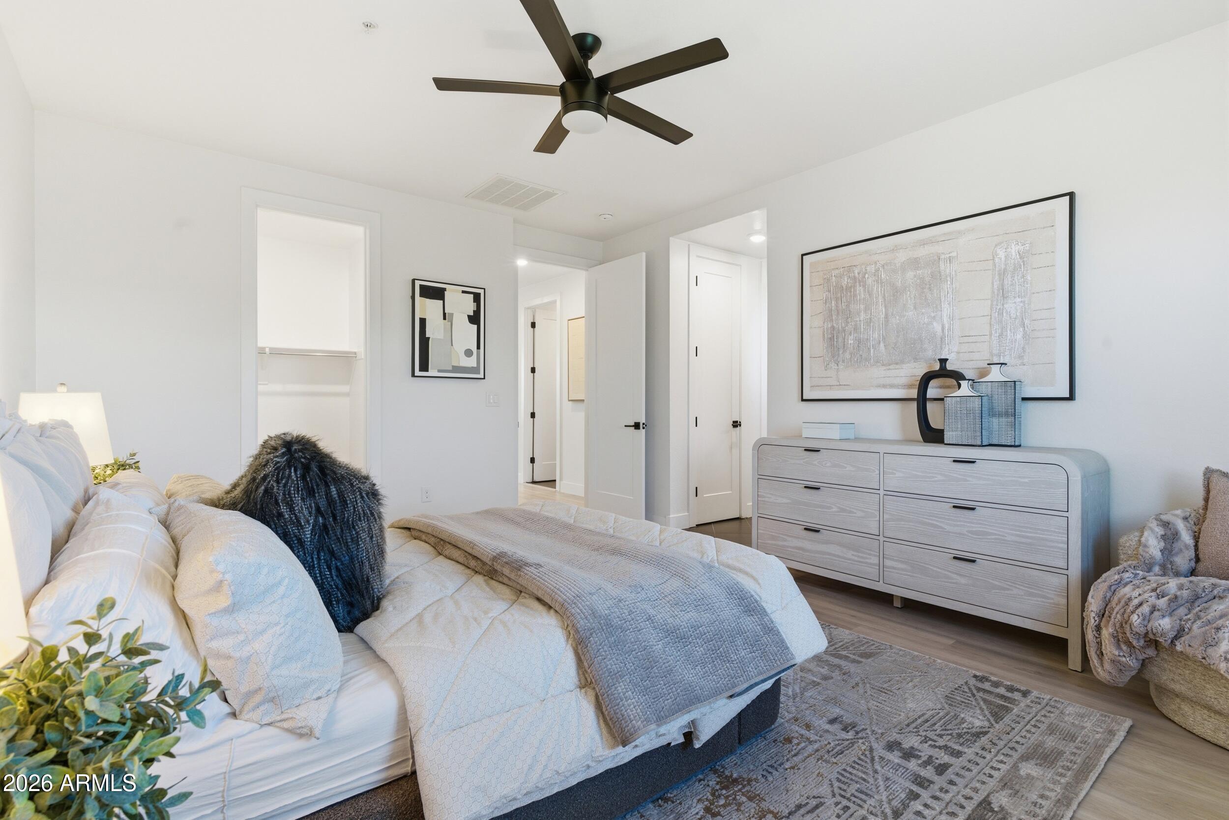 3855 South McQueen Road, Unit 34 Chandler, AZ 85286 - Photo 27 of 48 a bedroom with a bed and a chandelier