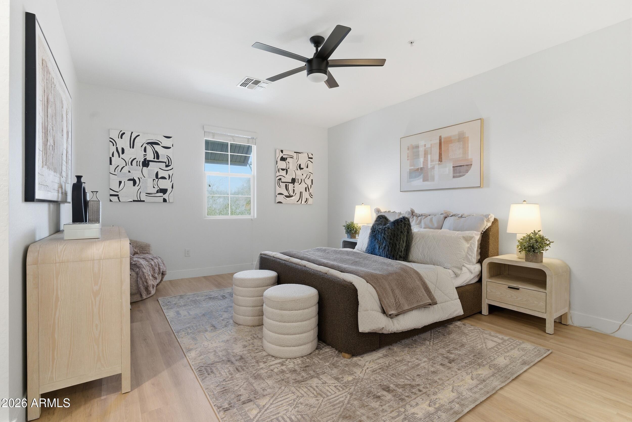 3855 South McQueen Road, Unit 34 Chandler, AZ 85286 - Photo 28 of 48 a bedroom with bed and a chandelier