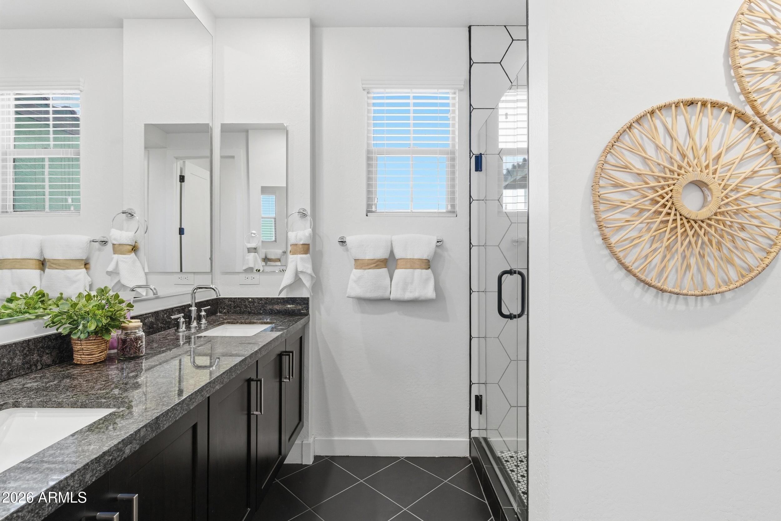 3855 South McQueen Road, Unit 34 Chandler, AZ 85286 - Photo 30 of 48 a bathroom with a granite countertop sink a mirror and a shower